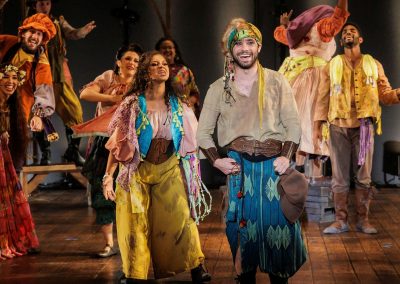 Dino Nicandros as Clopin and the ensemble of The REV Theatre Company’s production of THE HUNCHBACK OF NOTRE DAME, running July 13-August 2 at the Merry-Go-Round Playhouse in Auburn, NY.