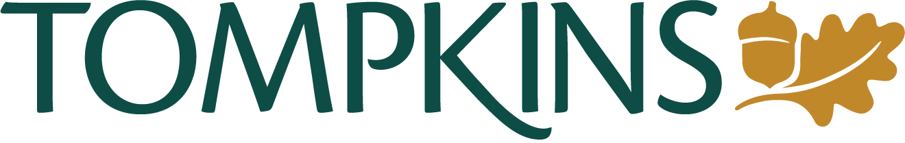 Tomp_logo Color High Res_NO TAG – The REV Theatre Co. | Broadway in the Finger Lakes Tompkins logo: green wordmark with an acorn and oak leaf symbol in gold beside the name